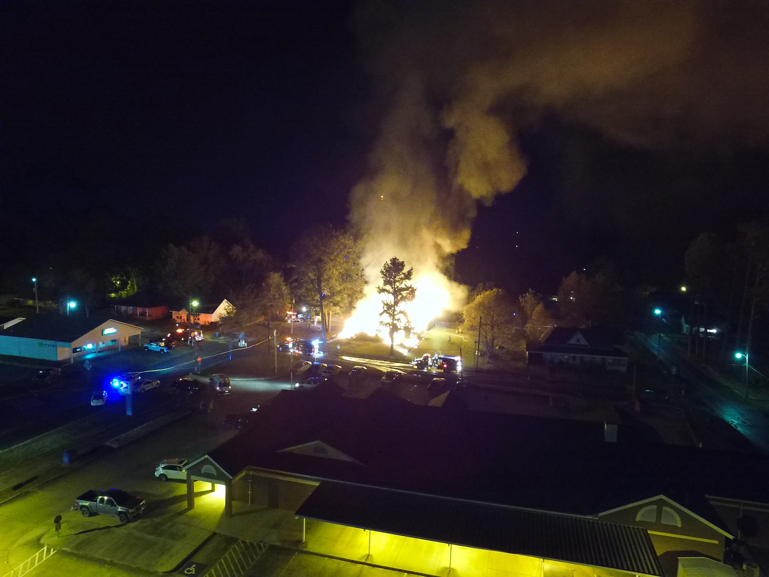 A fire is burning in the middle of an industrial area.