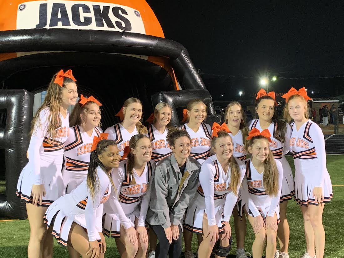 A group of cheerleaders posing for a picture.