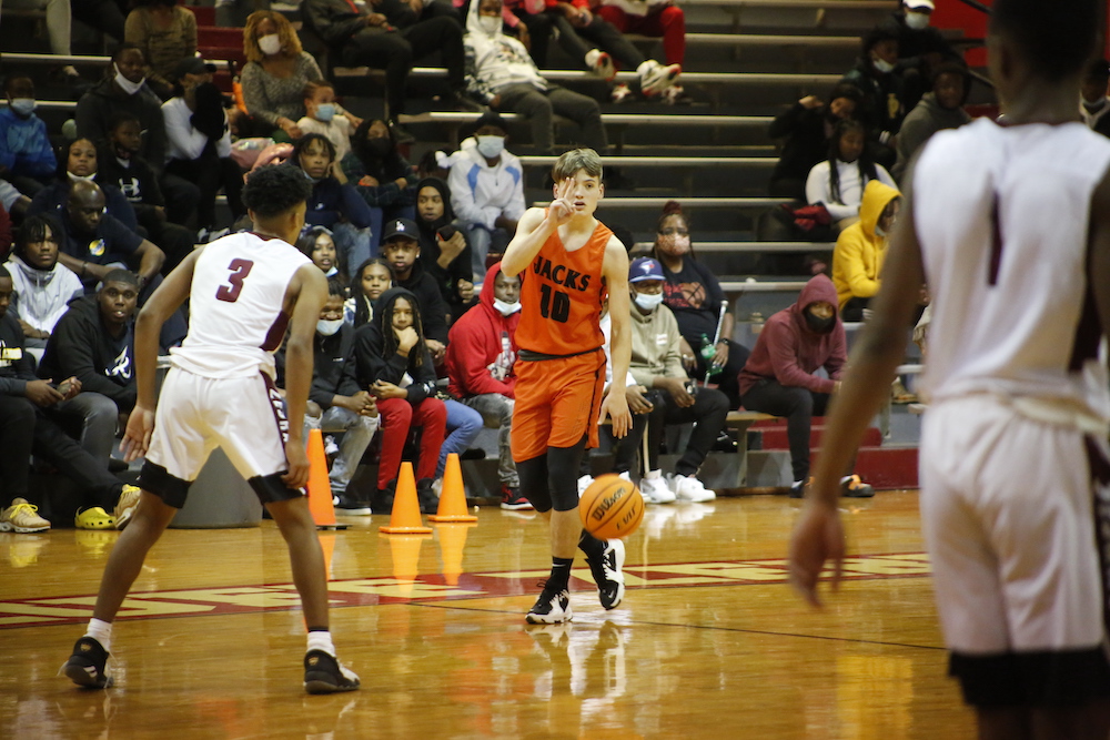 A group of men playing basketball on a court.
