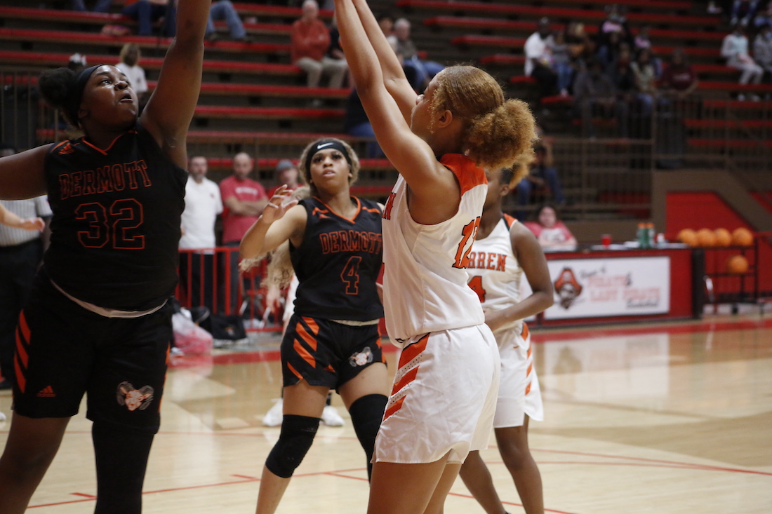 A group of women playing basketball on a court.