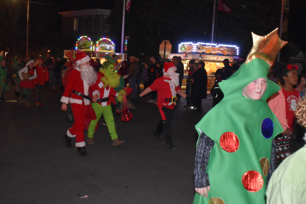 A group of people dressed as santa and elf
