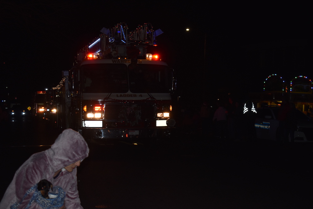 A fire truck is parked in the dark.