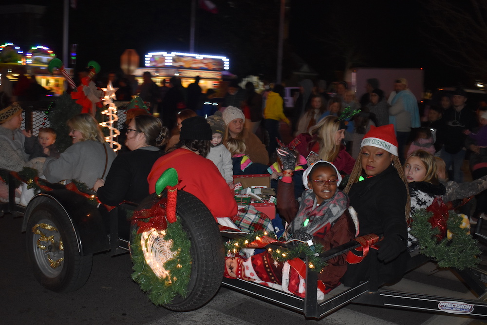A group of people sitting in the back of a sled.