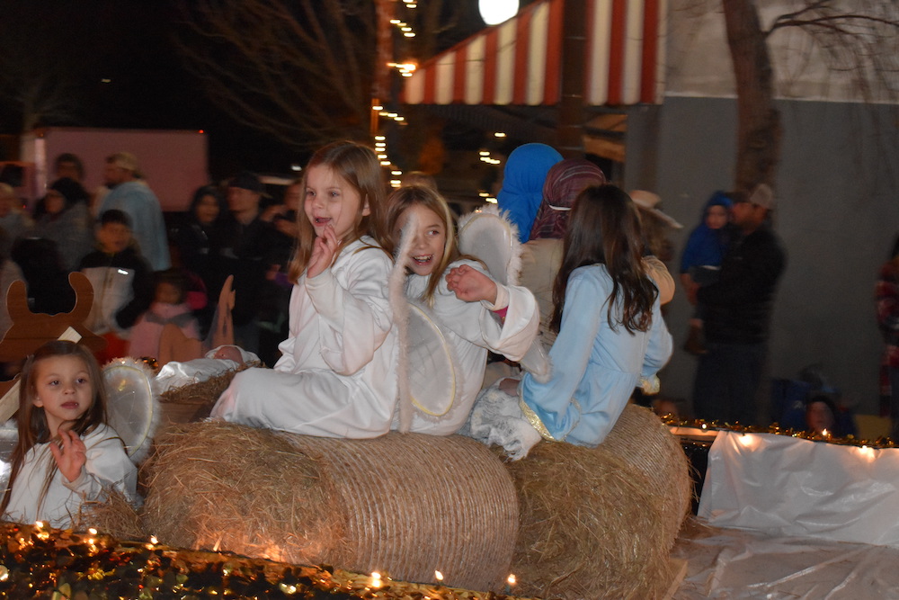 A group of children riding on hay bales.