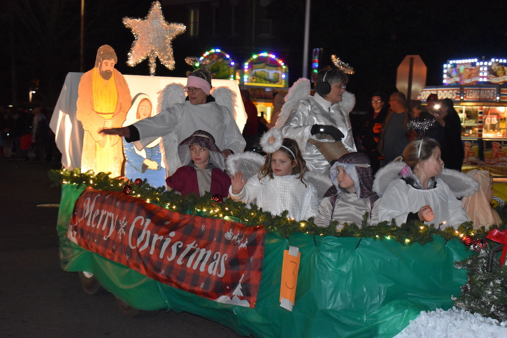 A group of people riding on the back of a float.