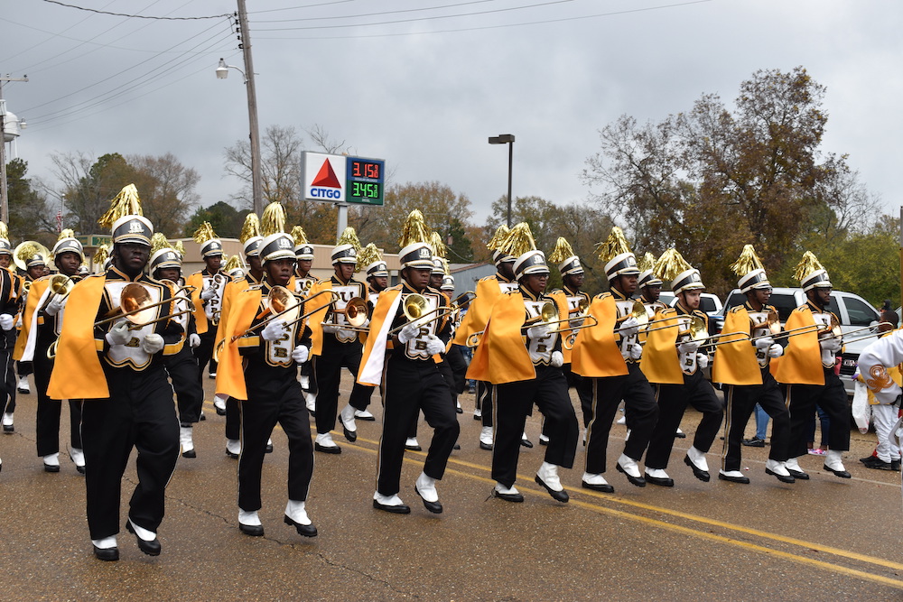 A group of people marching down the street