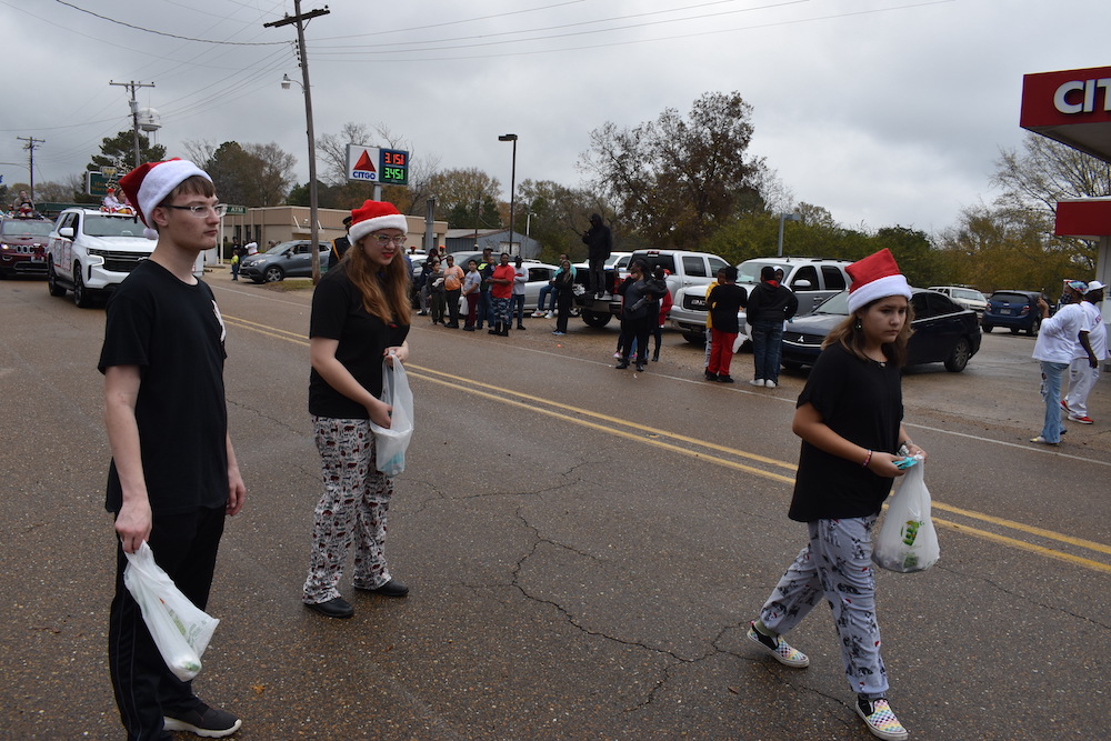 A group of people walking down the street