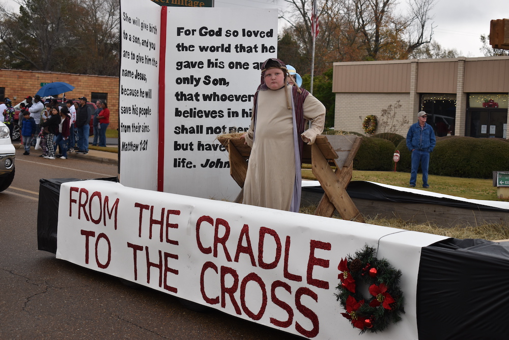 A man in costume standing next to a sign.
