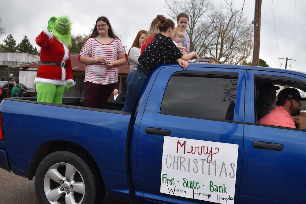 A blue truck with a sign that says merry christmas.