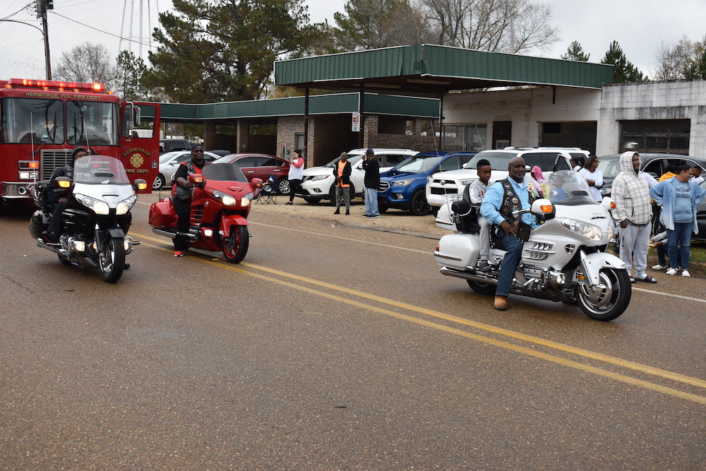 A group of people riding motorcycles on the street.