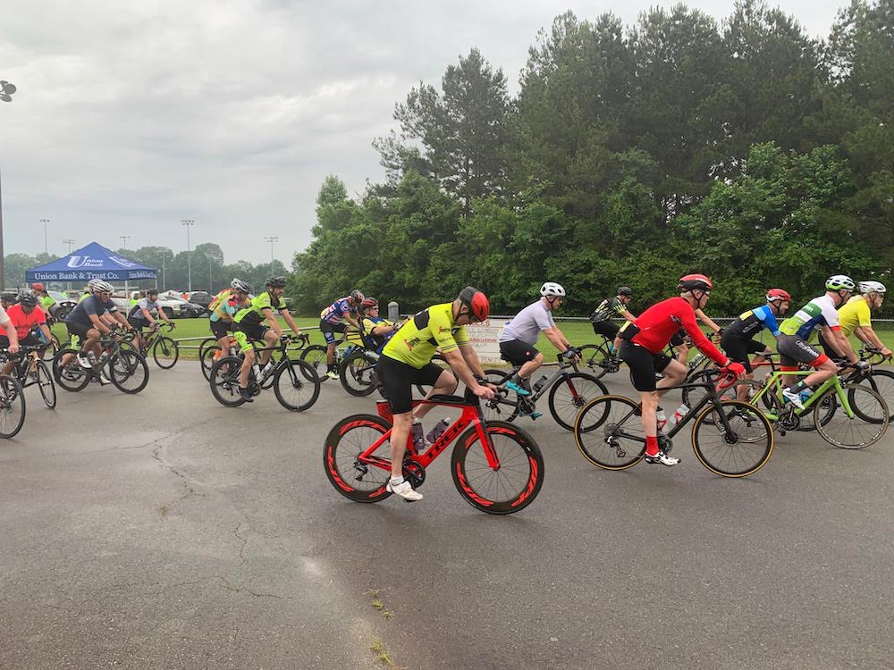 A group of people riding bikes on the road.