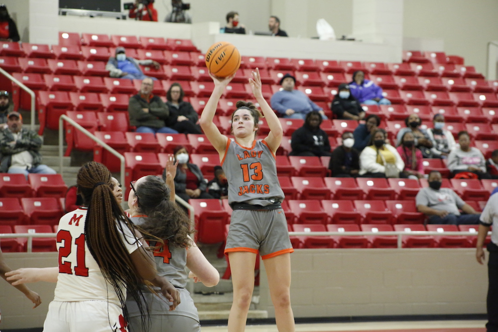 A person is holding a basketball in the air