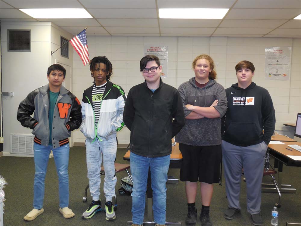 A group of people standing in front of an american flag.