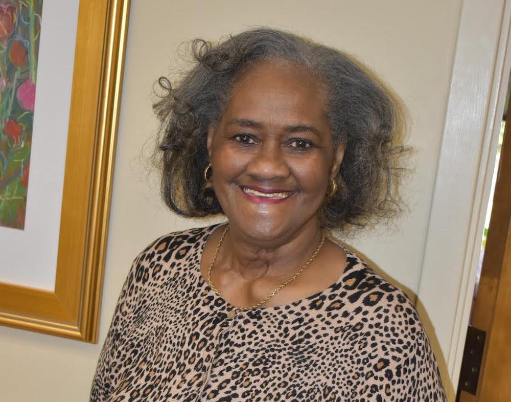 A woman with curly hair and leopard print shirt.