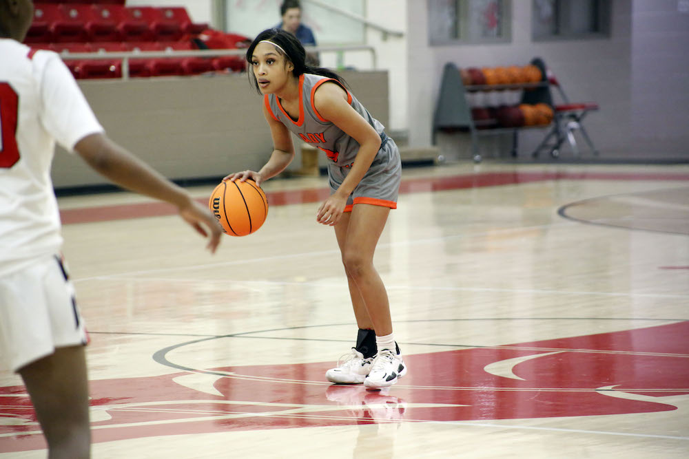 A girl is playing basketball on the court