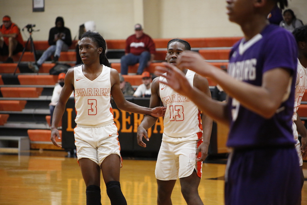 A group of men playing basketball on a court.