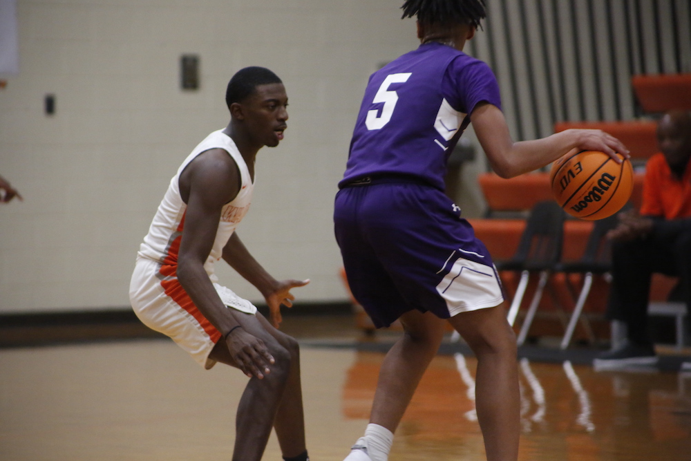 Two men playing basketball on a court