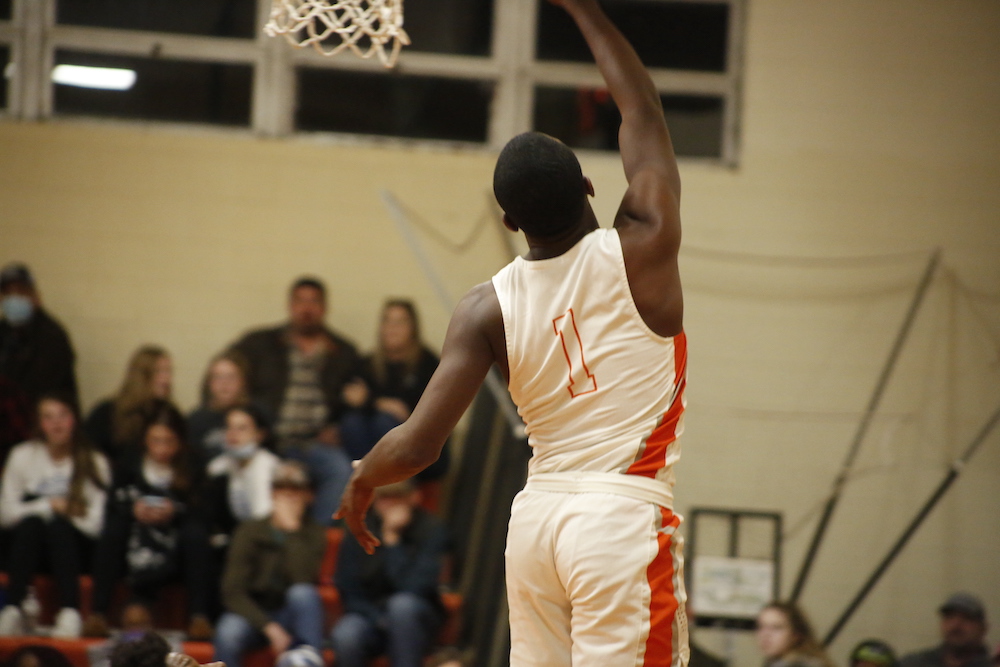 A man in white and orange basketball uniform playing basketball.