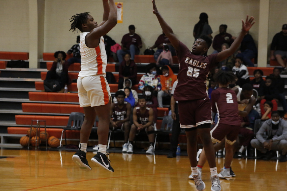 A group of people playing basketball on a court.