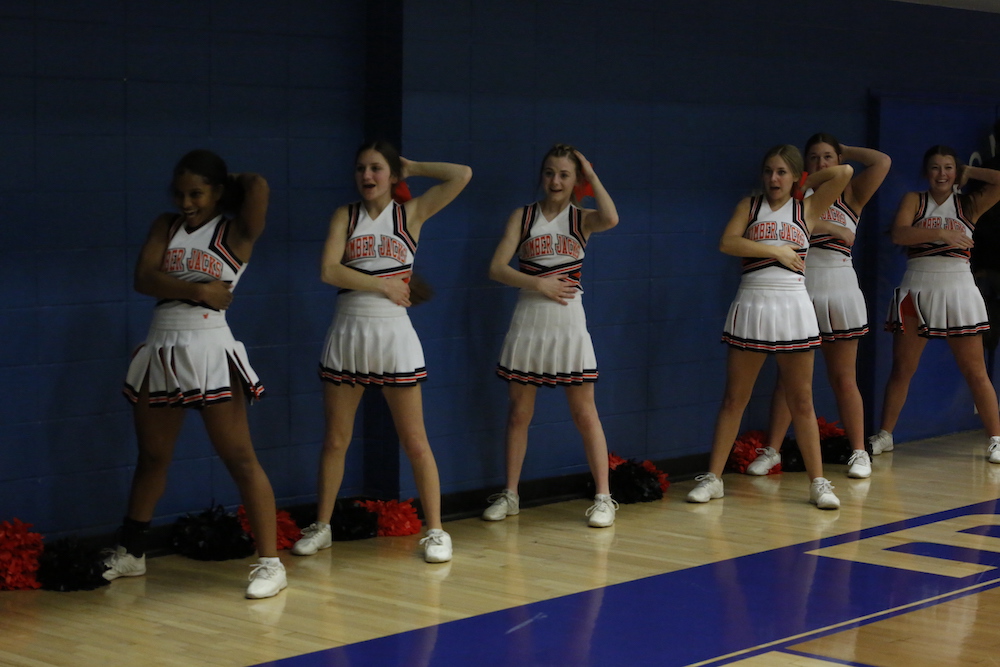 A group of cheerleaders standing in front of each other.