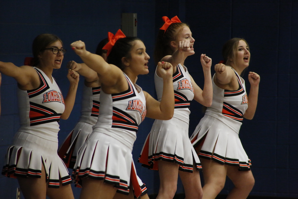 A group of cheerleaders are standing in formation.