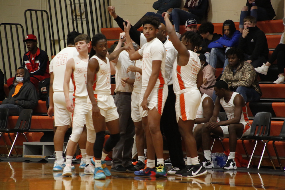 A group of men standing on top of a basketball court.