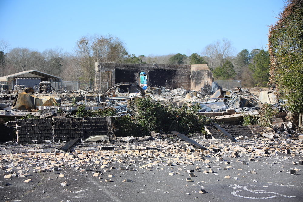 A large pile of rubble in front of a building.