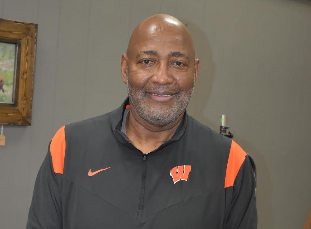 A man in an orange and black shirt.