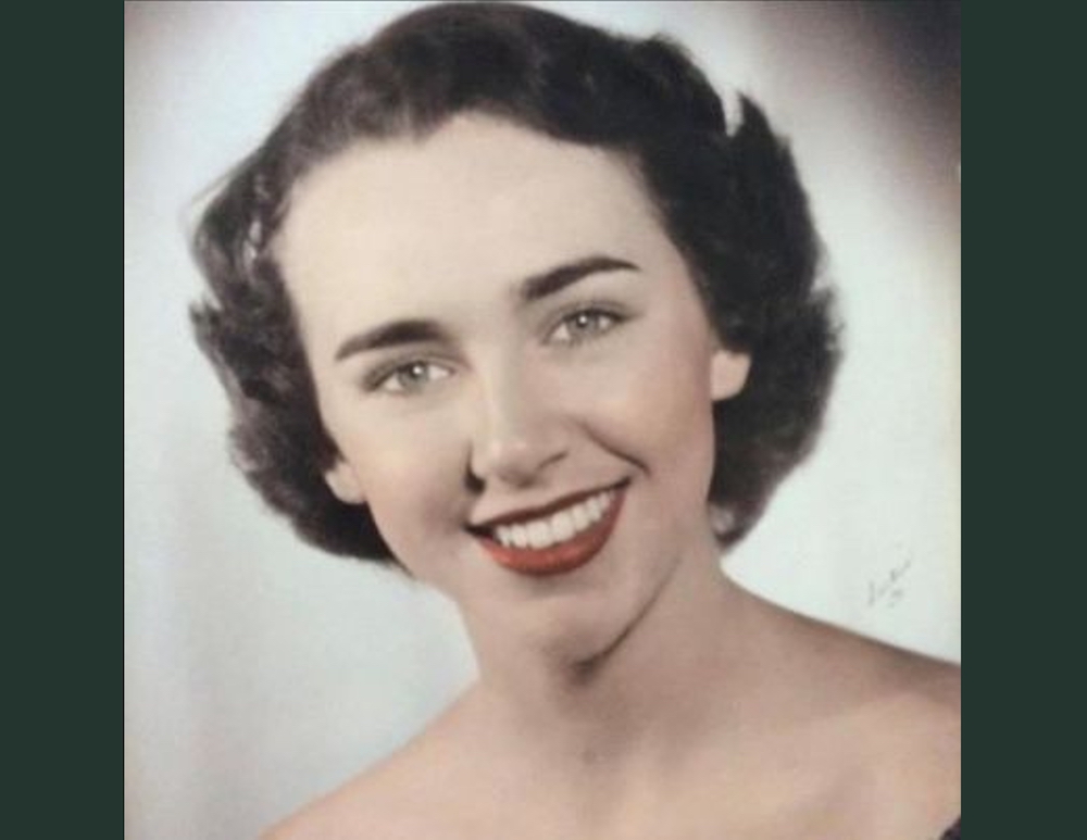 A woman with short hair and red lipstick.