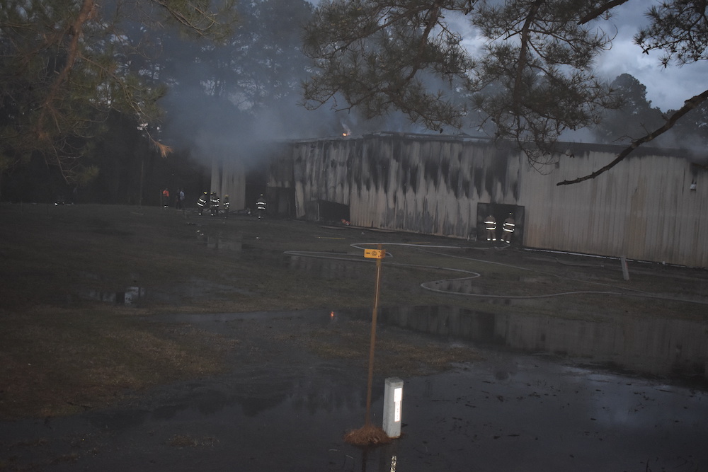 A fire hydrant in the middle of a flooded area.