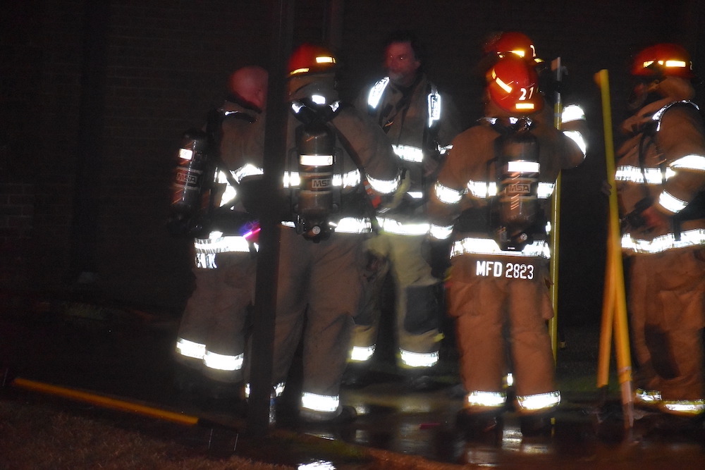 A group of firefighters standing next to each other.