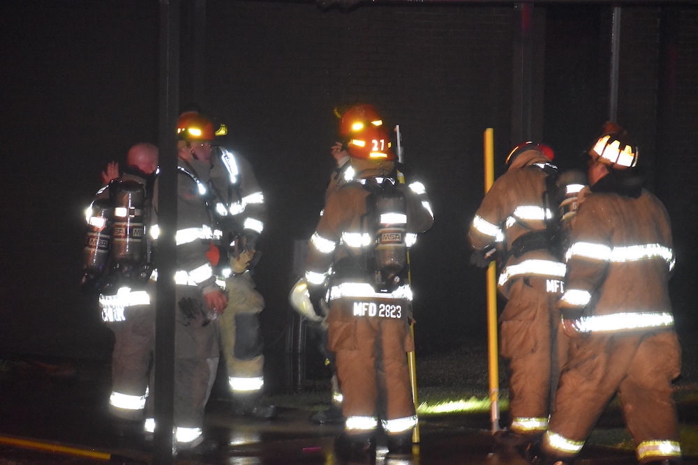 A group of firefighters standing next to each other.