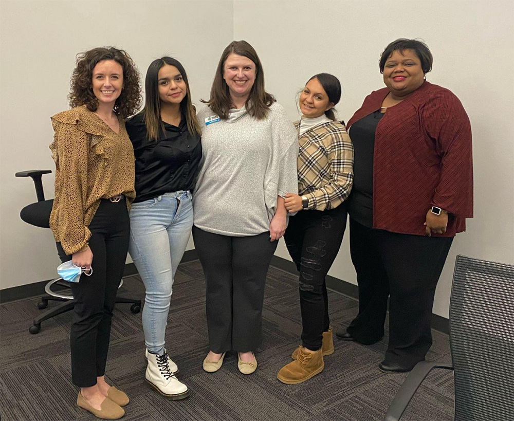 A group of women standing next to each other.