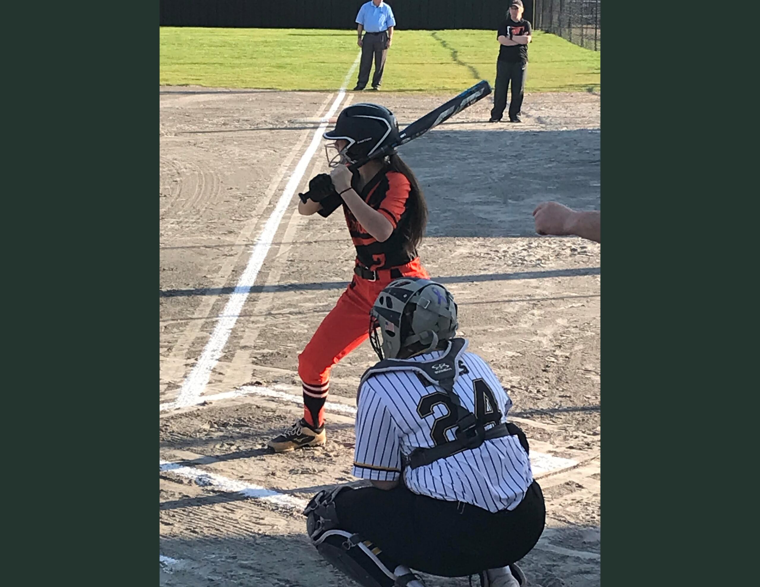 A baseball player is swinging at the ball.