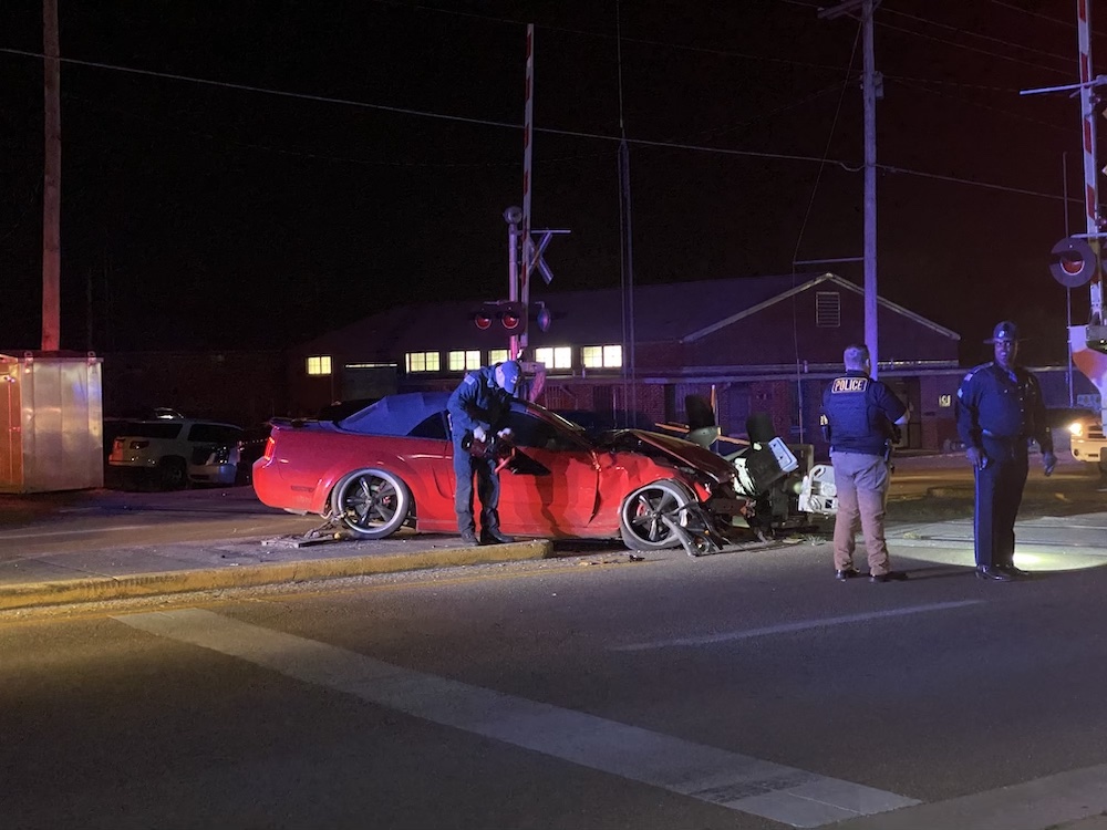A red car that is sitting on the side of a road.