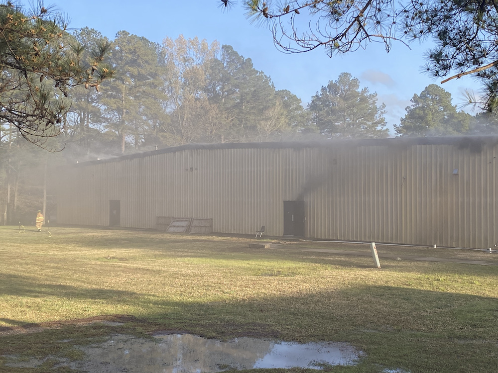 A building with smoke coming out of it.