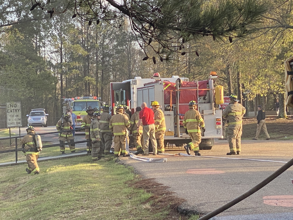 A group of people standing next to a fire truck.