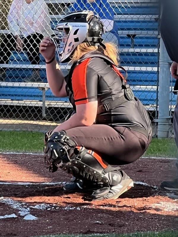 A softball player is about to throw the ball.