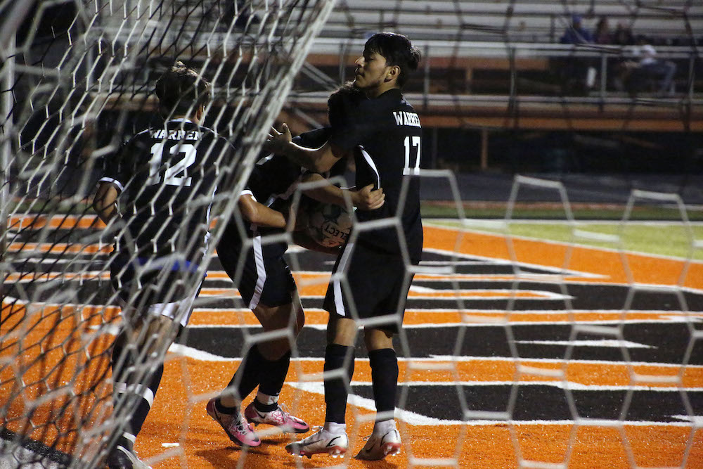 A softball player is about to throw the ball.