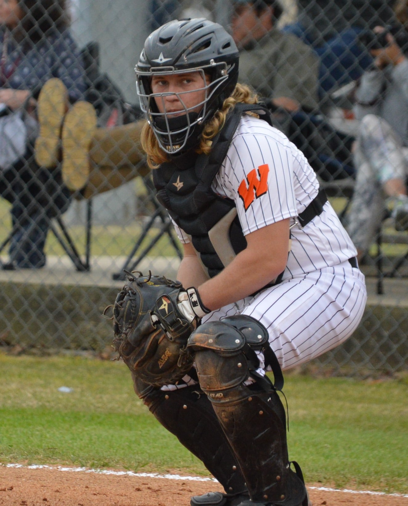 A catcher in the middle of a baseball game.