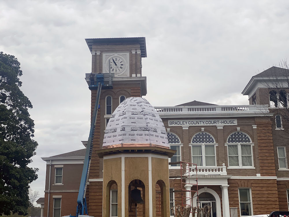 A building with a clock tower in the background.