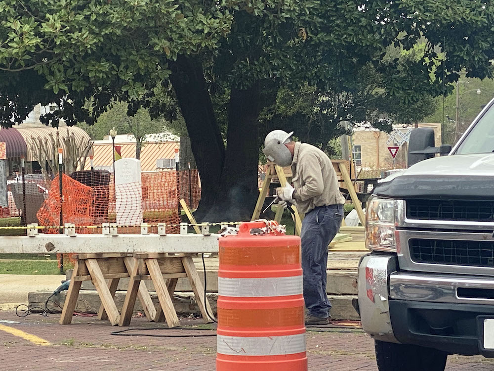A man standing next to a table with construction equipment.
