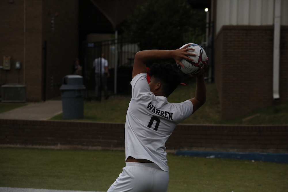 A person with a soccer ball in the air