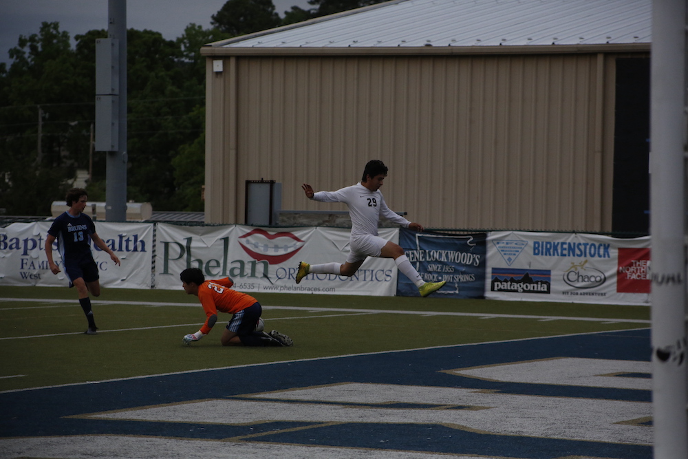 A man jumping in the air while playing soccer.