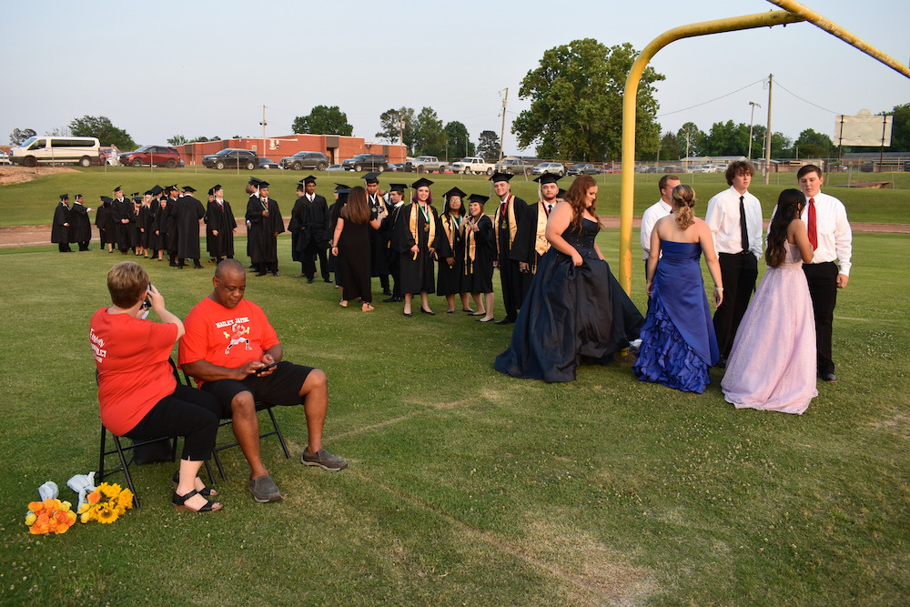A group of people in long gowns and hats.