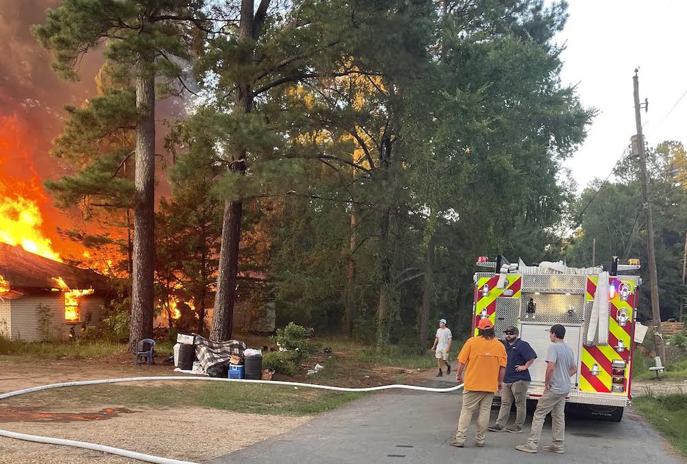 A group of people standing around a fire truck.