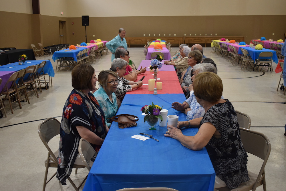 A group of people sitting at a table with drinks.