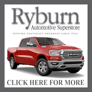 A red truck is parked in front of the ryburn automotive superstore.