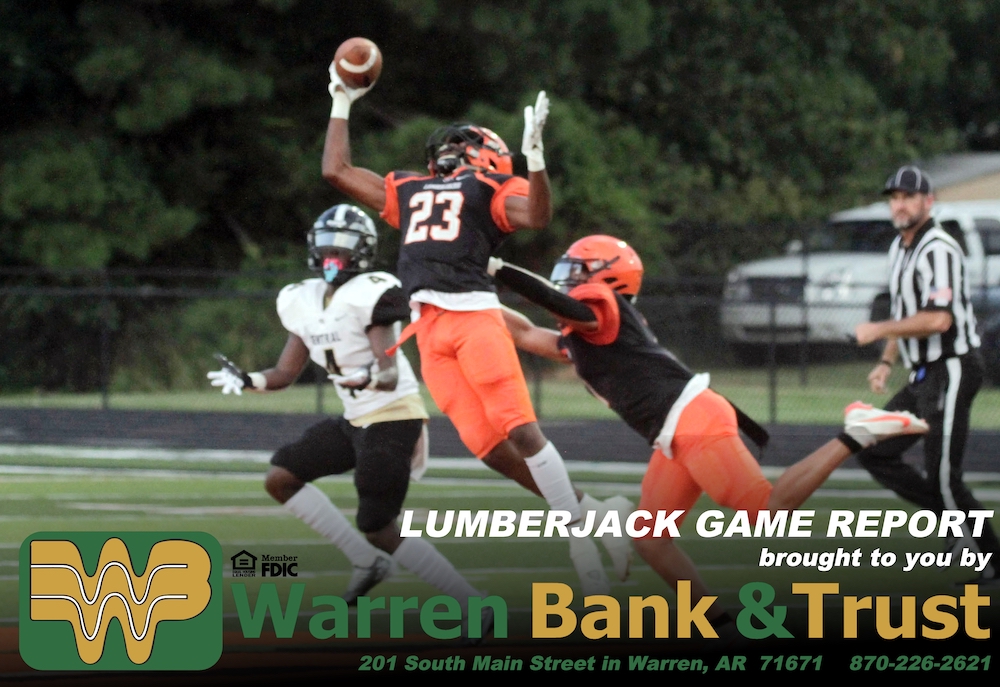 A football player is jumping to catch the ball.