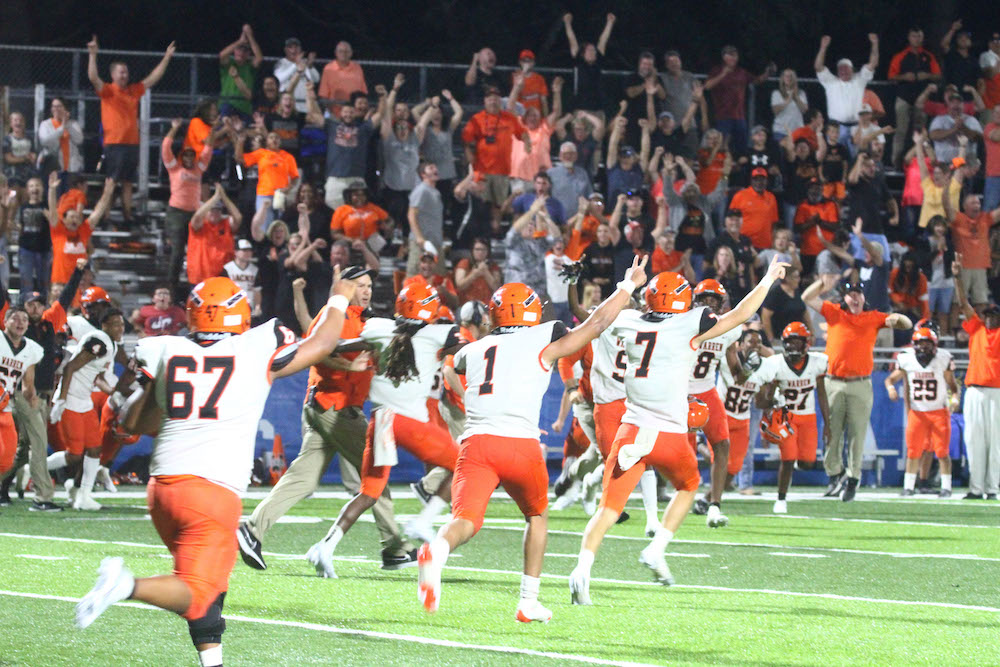 A group of people on a field playing football.